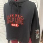Sample stitch out of "In my self love era" embroidered on a black jacket