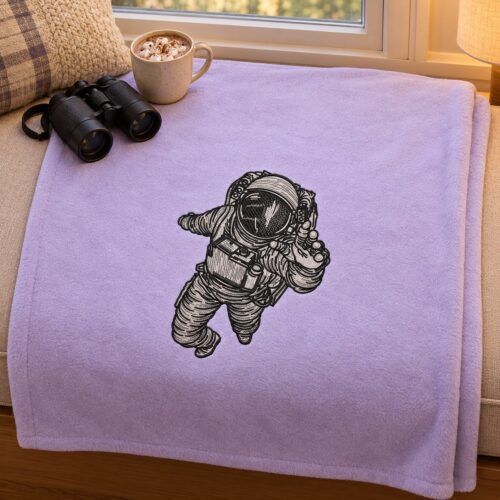 Cosmonaut in Space embroidery design stitched on a throw blanket
