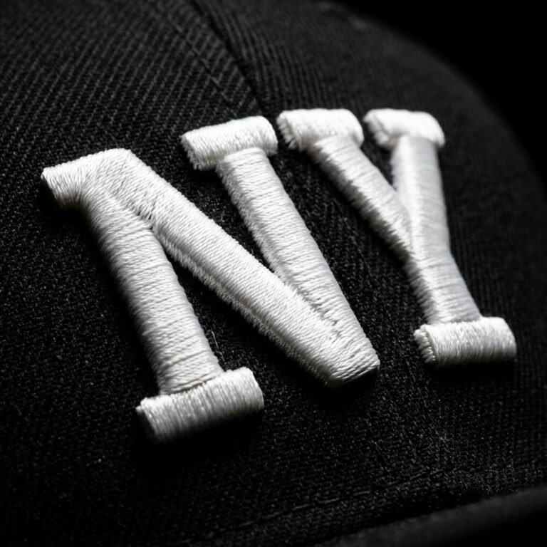 3D puff embroidery raised satin lettering close-up on snapback hat by ABDigitizing