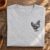 Rustic Farmhouse Hen Sketch embroidery design stitched as a left-chest logo on a t-shirt