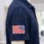 Reversed USA Flag embroidery design stitched on a polo sleeve