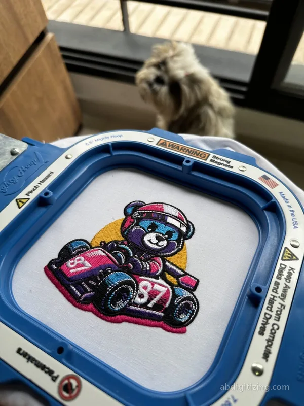 Cute bear racing a car embroidery design