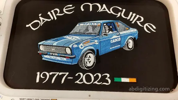 blue Race car machine embroidery design outcome on a black jacket