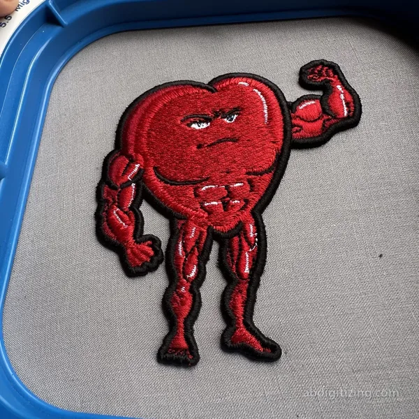 red heart with muscles flexing his biceps in 3d puff machine embroidery design