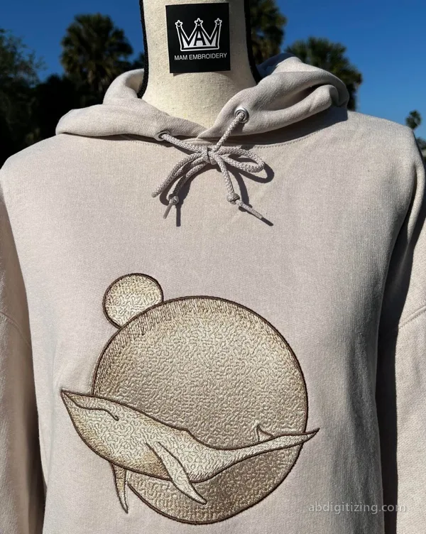 Big whale floating in front of a planet embroidered on a Jacket